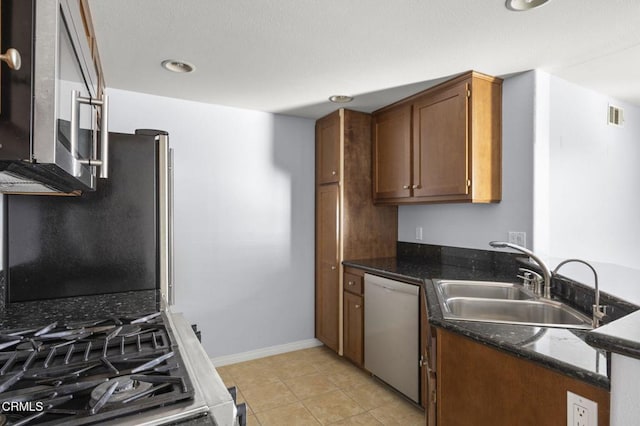 kitchen with light tile patterned floors, visible vents, dishwasher, a peninsula, and a sink