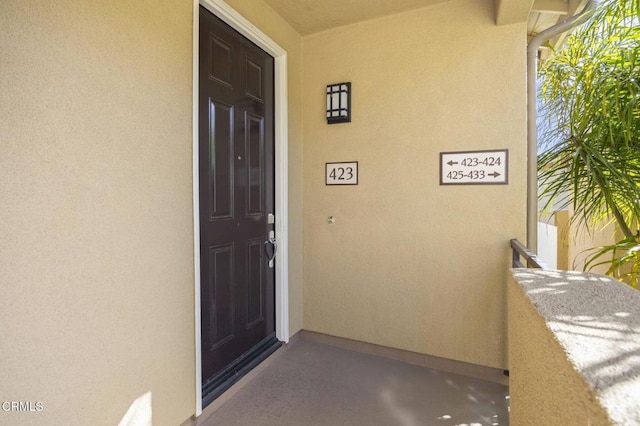 doorway to property with stucco siding