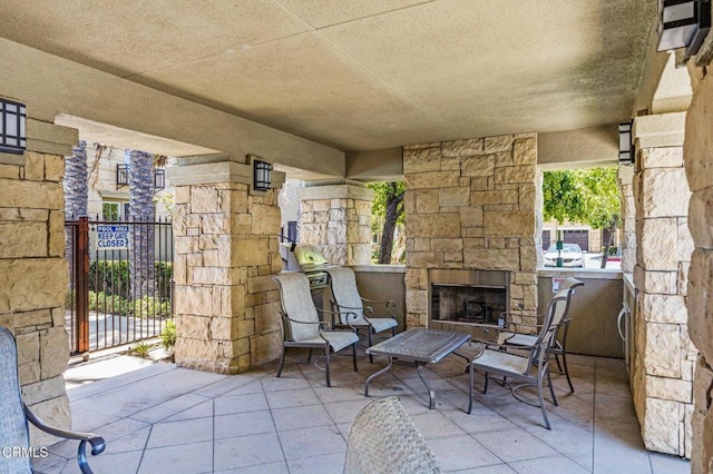 view of patio / terrace featuring an outdoor stone fireplace