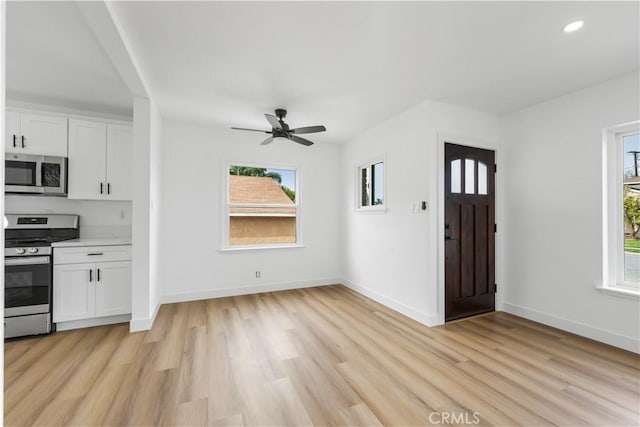 interior space featuring plenty of natural light, white cabinetry, and stainless steel appliances