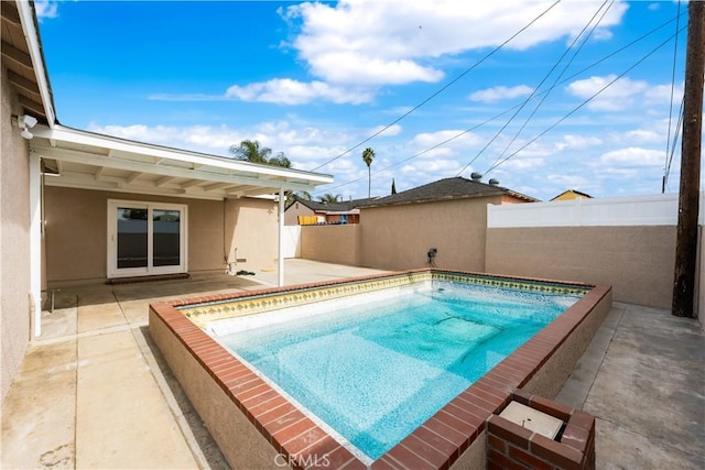 view of swimming pool with a patio area, fence, and a fenced in pool