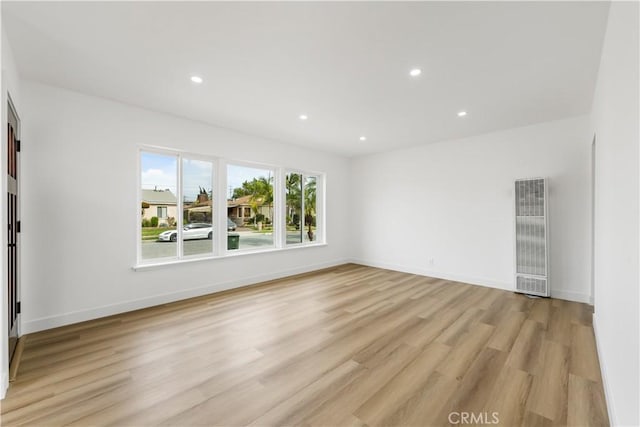 unfurnished room with baseboards, recessed lighting, visible vents, and light wood-style floors