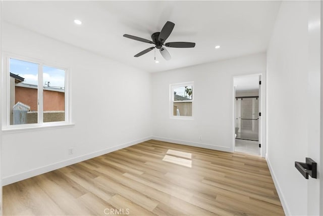 unfurnished bedroom featuring recessed lighting, light wood-style flooring, and baseboards