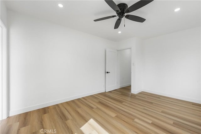 spare room featuring baseboards, ceiling fan, recessed lighting, and light wood-style floors