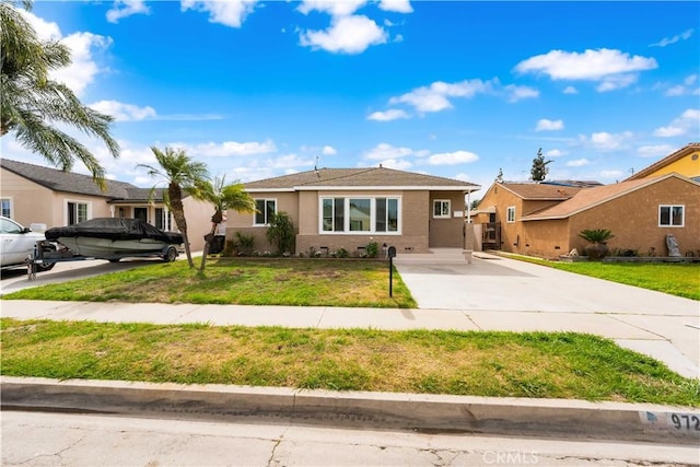 ranch-style house with a front yard and stucco siding