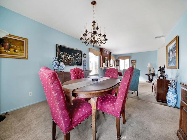 carpeted dining area with a chandelier, visible vents, and baseboards