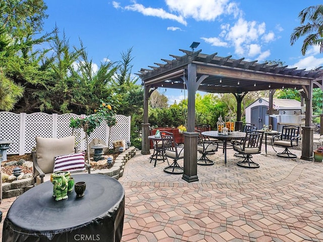 view of patio / terrace featuring outdoor dining space, an outbuilding, a storage shed, and a pergola