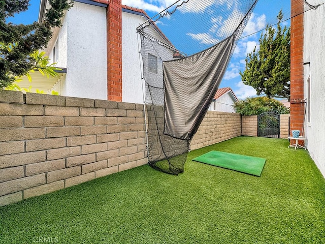 view of property exterior with a lawn, fence, a gate, and stucco siding