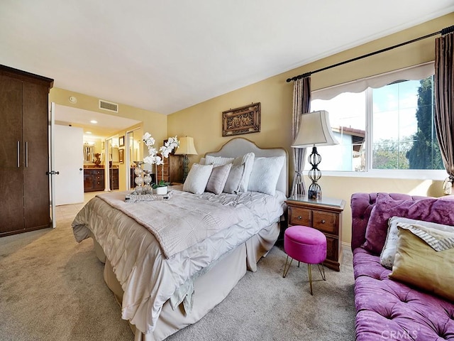 bedroom featuring light carpet and visible vents