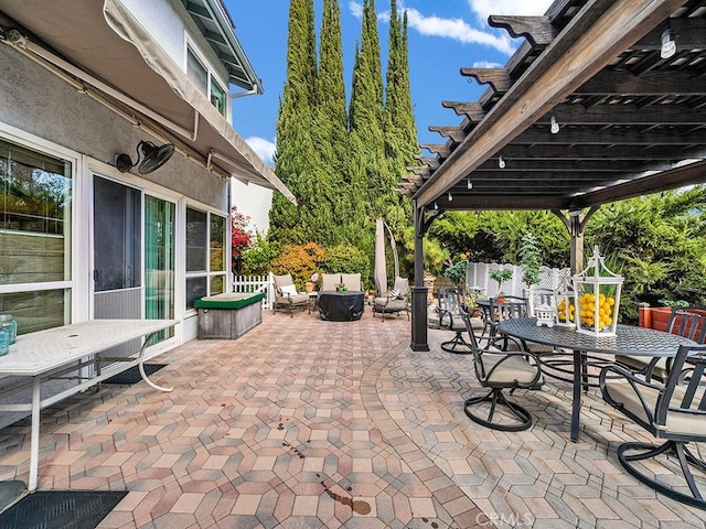 view of patio featuring outdoor dining area and fence