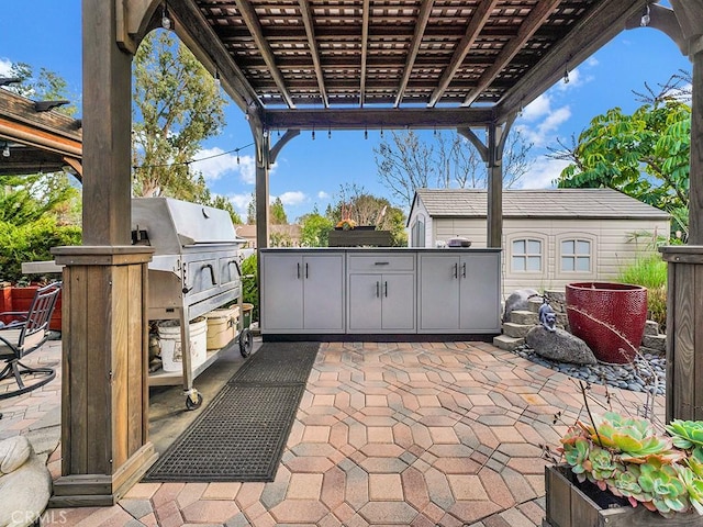 view of patio / terrace with area for grilling and a pergola