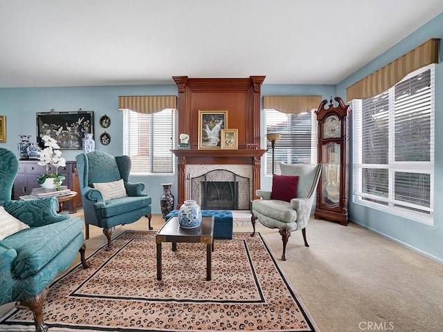 living area with a large fireplace and light colored carpet