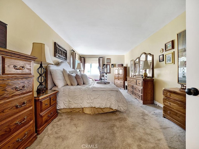 bedroom featuring light carpet