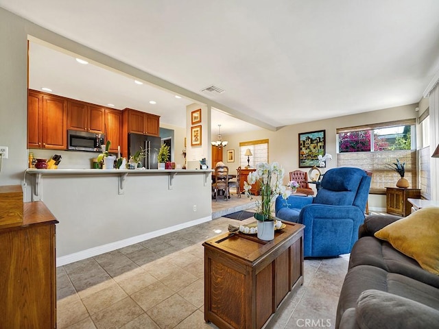 living room with light tile patterned floors, recessed lighting, visible vents, an inviting chandelier, and baseboards