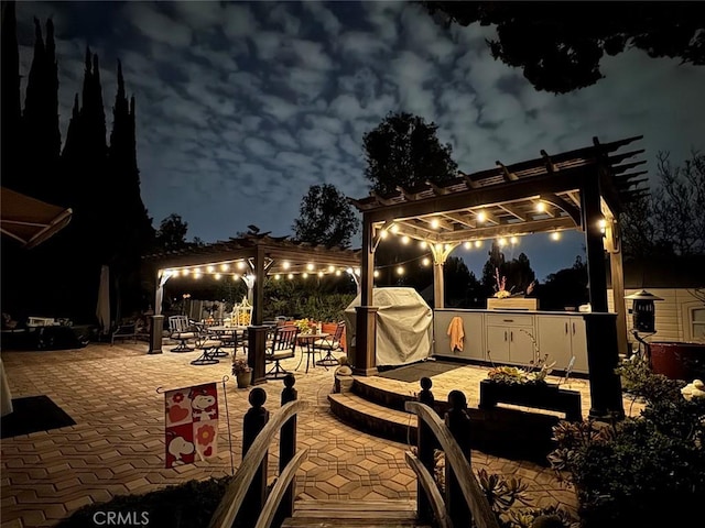 exterior space with a grill and a pergola