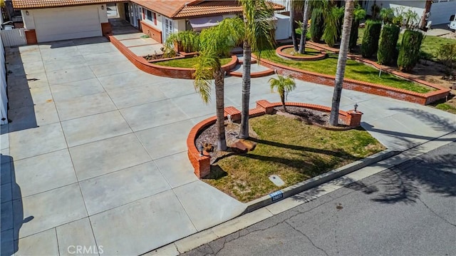 view of property's community with a garage and concrete driveway