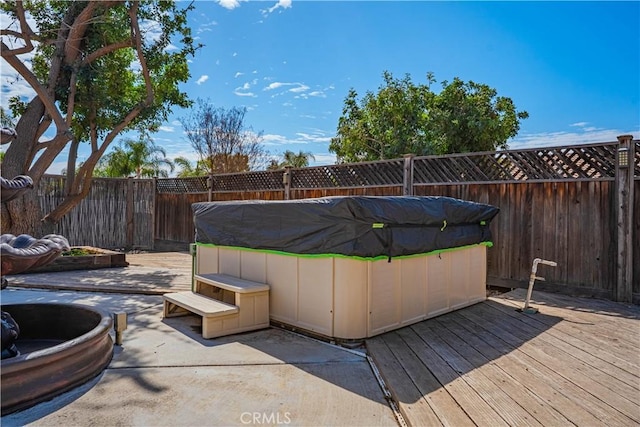 wooden deck featuring a fenced backyard and a pool