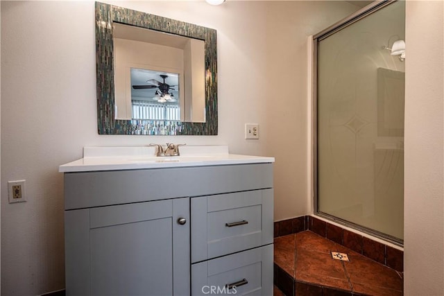 bathroom featuring a stall shower, a ceiling fan, and vanity