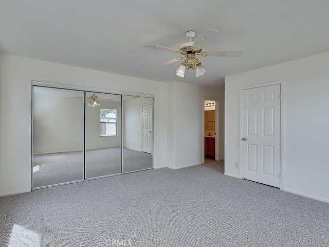 unfurnished bedroom featuring ceiling fan, a closet, baseboards, and carpet flooring