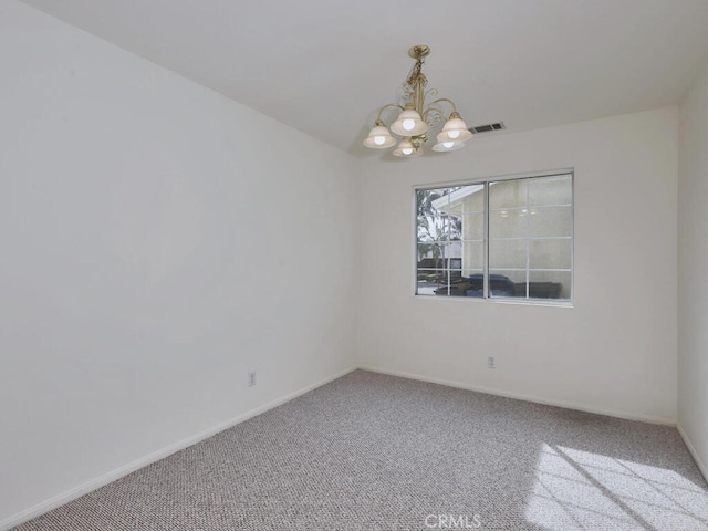 unfurnished room featuring baseboards, carpet floors, visible vents, and a notable chandelier