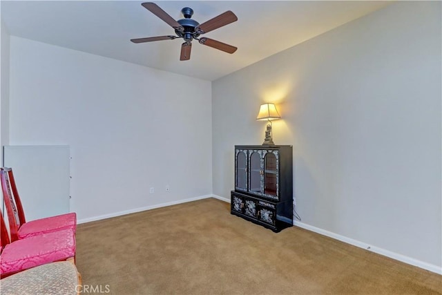 living area with a ceiling fan, carpet flooring, and baseboards