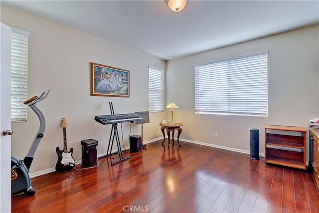 interior space with baseboards and wood finished floors