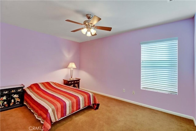 bedroom with a ceiling fan, carpet, and baseboards