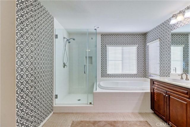 full bathroom with a garden tub, a shower stall, vanity, and tile patterned floors