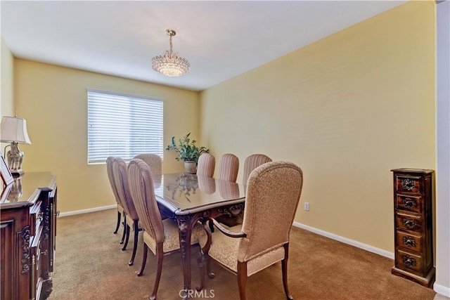 dining room with carpet floors and baseboards