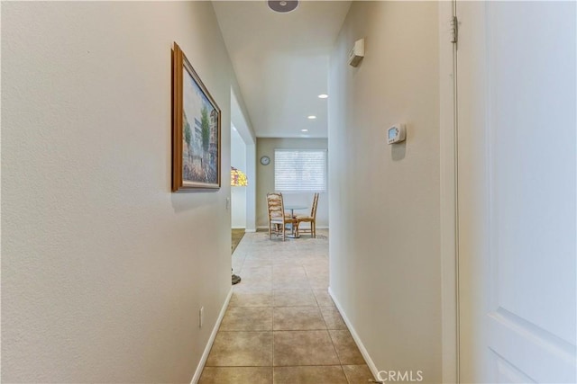 hall with light tile patterned floors, recessed lighting, and baseboards