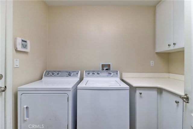 laundry area featuring washer and dryer and cabinet space