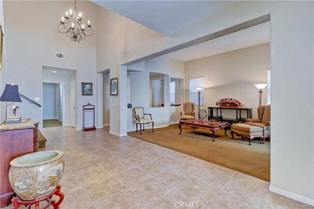 entryway featuring light tile patterned floors, a chandelier, visible vents, and light colored carpet