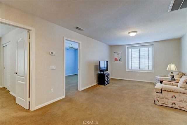 sitting room with light carpet, baseboards, and visible vents