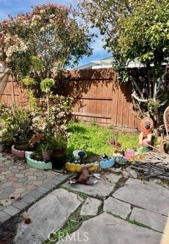 view of yard with fence and a patio