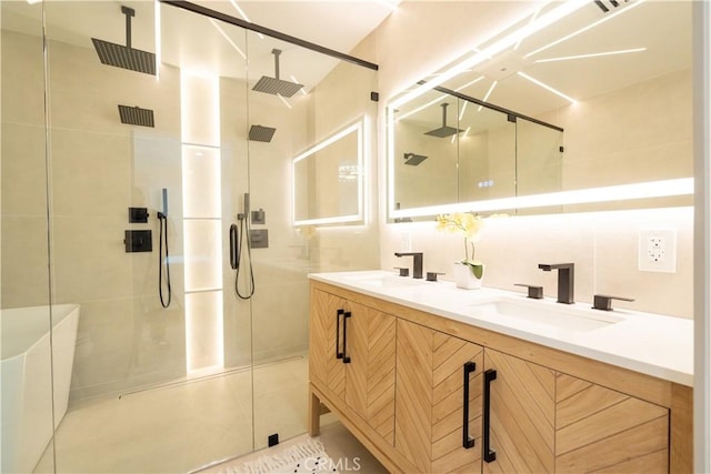 full bathroom featuring double vanity, a shower stall, and a sink