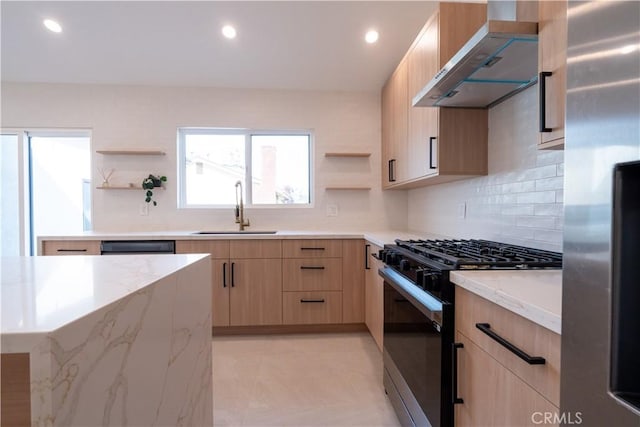 kitchen with wall chimney range hood, gas range oven, open shelves, and stainless steel fridge