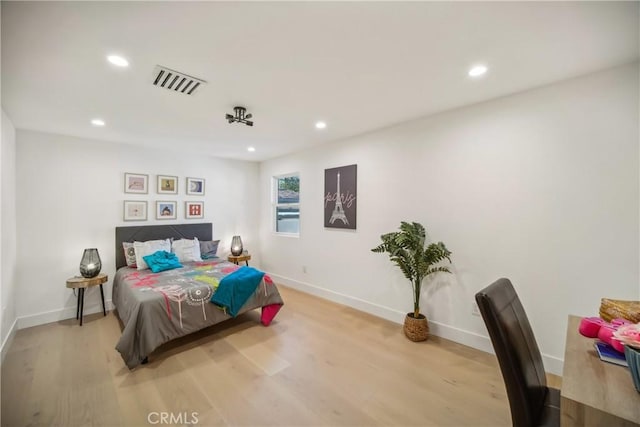 bedroom with recessed lighting, visible vents, and wood finished floors