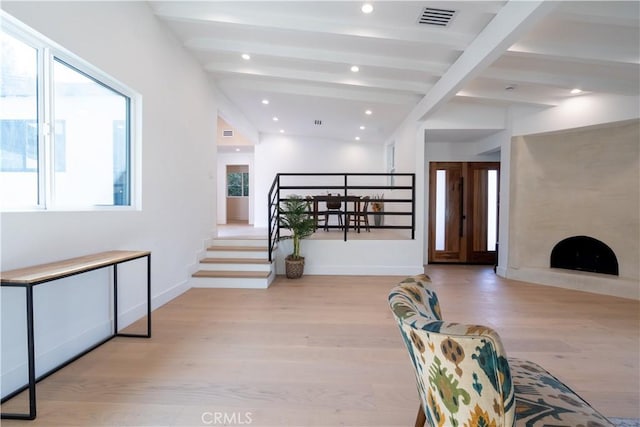 interior space featuring recessed lighting, visible vents, baseboards, light wood finished floors, and beamed ceiling