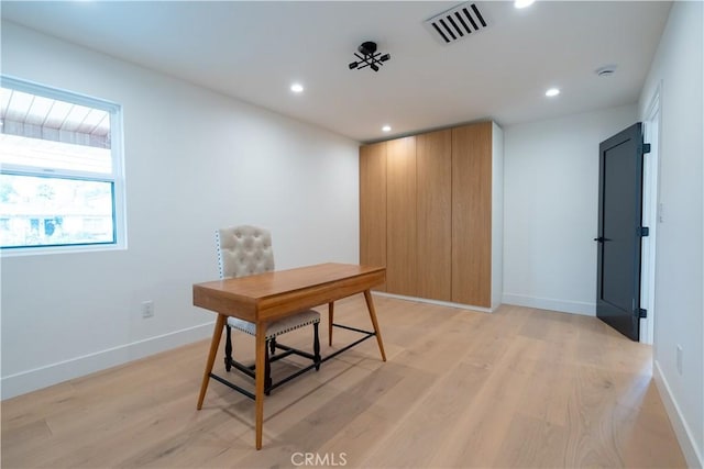 office space featuring baseboards, light wood finished floors, visible vents, and recessed lighting