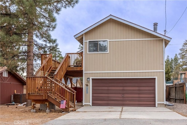 view of front of home with stairs, fence, and a deck