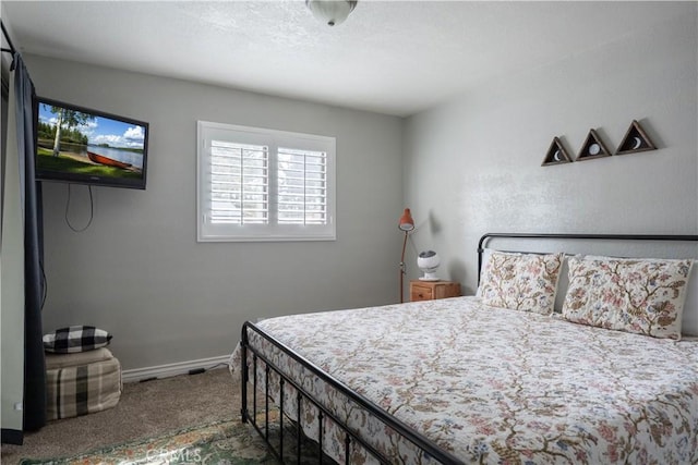 bedroom featuring carpet flooring and baseboards