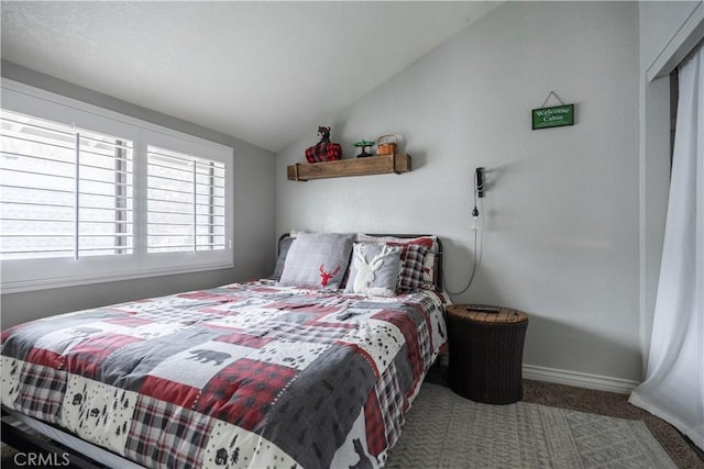 bedroom featuring vaulted ceiling, carpet, and baseboards