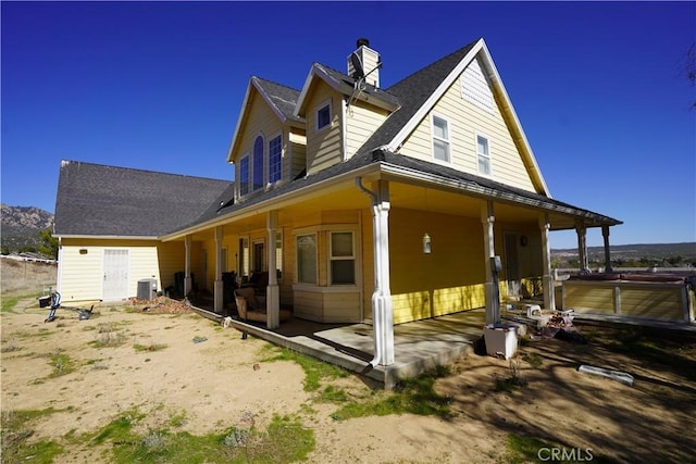 view of side of property with a patio area and central AC unit