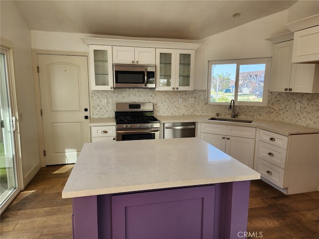 kitchen featuring stainless steel appliances, a sink, and light countertops