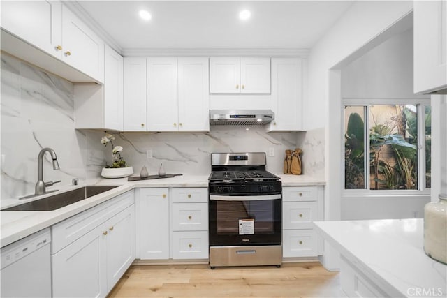 kitchen featuring extractor fan, white dishwasher, a sink, white cabinets, and stainless steel gas stove