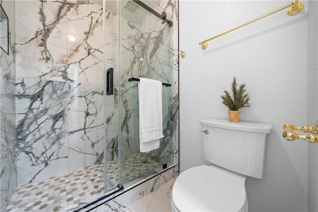 full bathroom with a marble finish shower, marble finish floor, and toilet