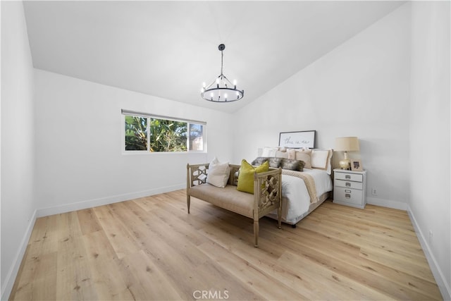 bedroom with lofted ceiling, baseboards, light wood-style flooring, and an inviting chandelier