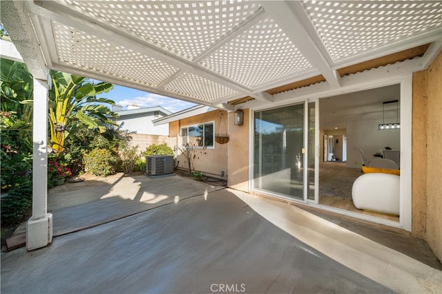 view of patio with central AC unit, fence, and a pergola