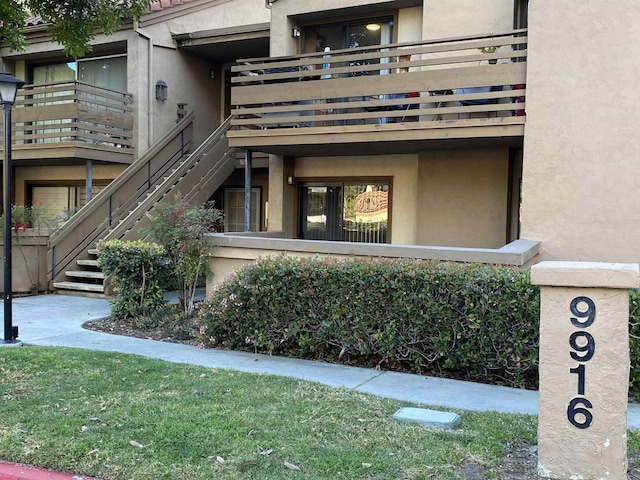 doorway to property featuring stucco siding