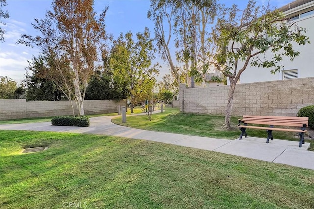 surrounding community featuring a yard and fence